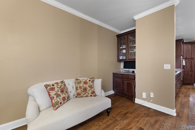 living area featuring baseboards, dark wood-style flooring, and crown molding