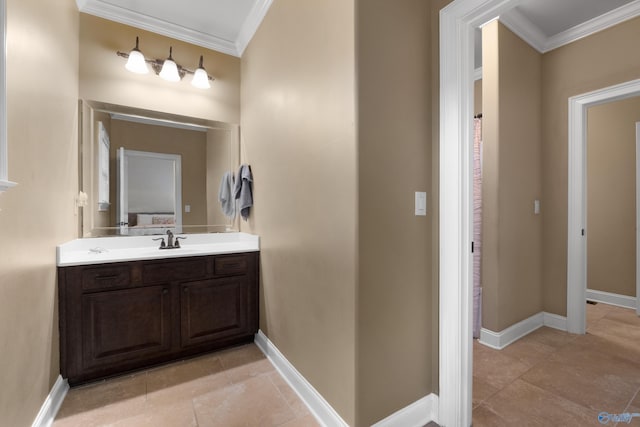 bathroom with baseboards, ornamental molding, and vanity