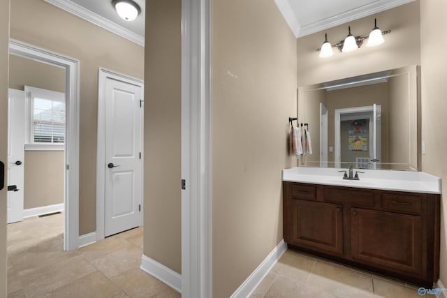 bathroom with baseboards, visible vents, vanity, and crown molding