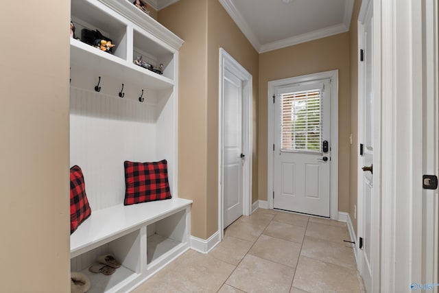 mudroom with light tile patterned flooring, crown molding, and baseboards