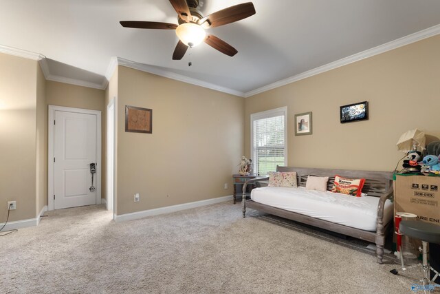 sitting room with carpet floors, a ceiling fan, baseboards, and crown molding