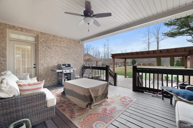 wooden terrace with ceiling fan, fence, and area for grilling