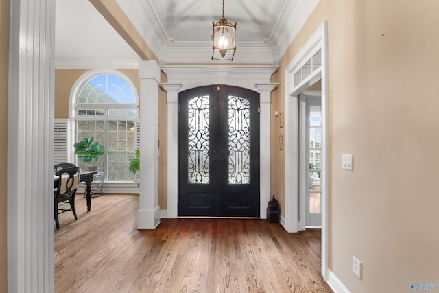 entryway featuring french doors, crown molding, baseboards, and wood finished floors