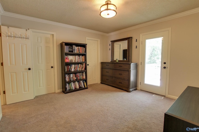 interior space featuring access to outside, a textured ceiling, visible vents, ornamental molding, and carpet flooring