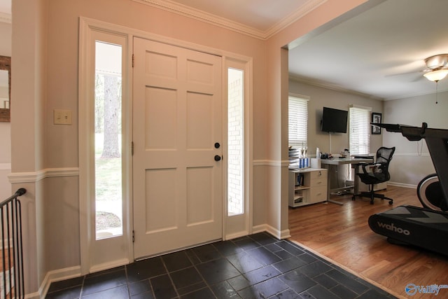 entrance foyer with crown molding, baseboards, and a ceiling fan