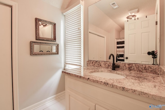 full bathroom with visible vents, tile patterned flooring, vanity, baseboards, and a textured ceiling