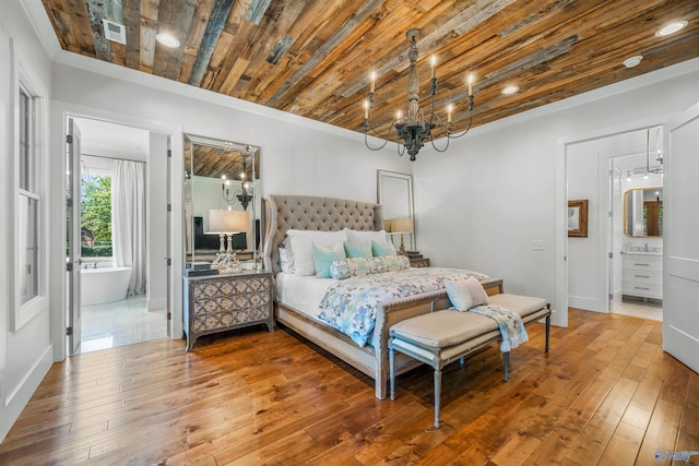 bedroom featuring visible vents, wood ceiling, wood-type flooring, ensuite bath, and an inviting chandelier