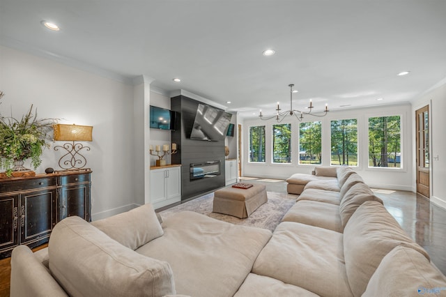 living area featuring recessed lighting, ornamental molding, a large fireplace, a chandelier, and baseboards