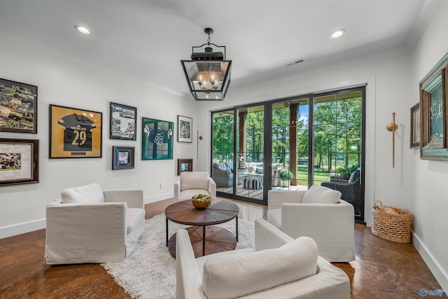 living room featuring crown molding and a notable chandelier