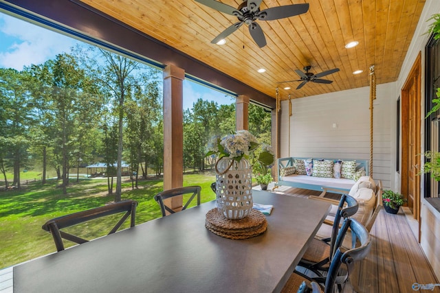 sunroom featuring wood ceiling and ceiling fan