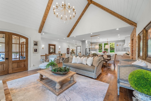 living room with wood-type flooring, beamed ceiling, french doors, high vaulted ceiling, and a notable chandelier
