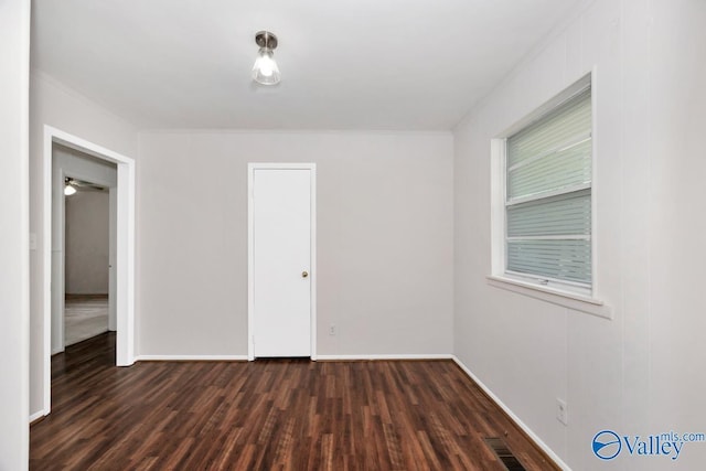 303 Bobwhite Dr SW, Decatur, AL 35601 - unfurnished bedroom with baseboards, ornamental molding, dark wood-style flooring, and visible vents