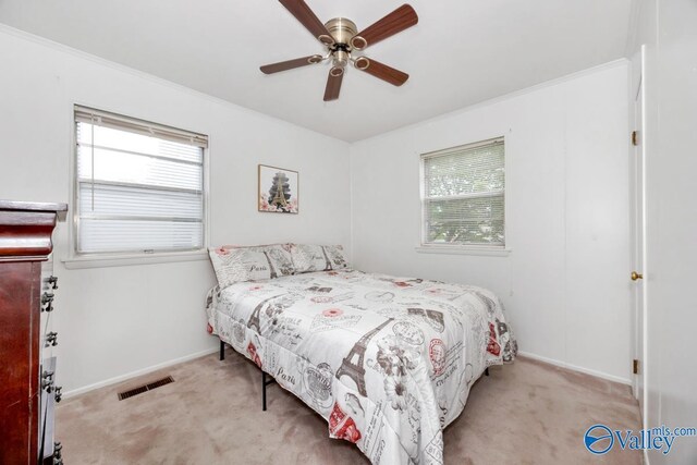 303 Bobwhite Dr SW, Decatur, AL 35601 - carpeted bedroom featuring crown molding, a ceiling fan, baseboards, and visible vents