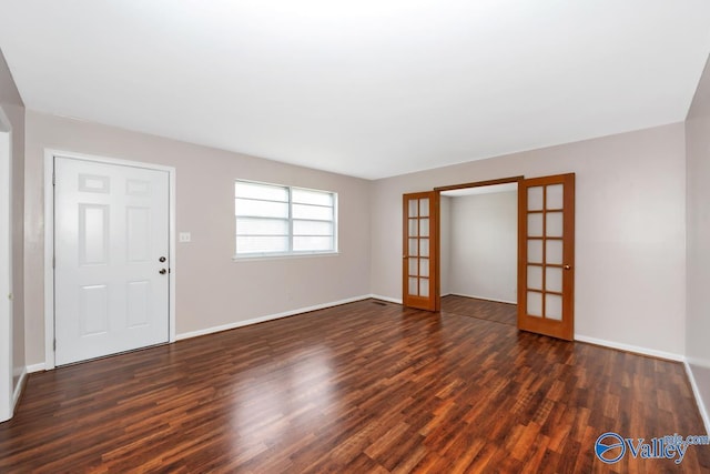 303 Bobwhite Dr SW, Decatur, AL 35601 - unfurnished living room featuring dark wood-style flooring, baseboards, and french doors