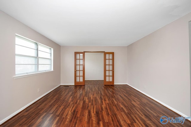 303 Bobwhite Dr SW, Decatur, AL 35601 - spare room featuring baseboards, dark wood finished floors, visible vents, and french doors