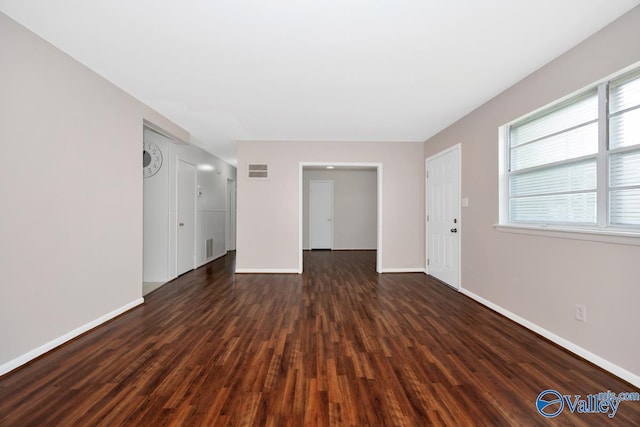 303 Bobwhite Dr SW, Decatur, AL 35601 - unfurnished living room with baseboards, plenty of natural light, dark wood-style flooring, and visible vents