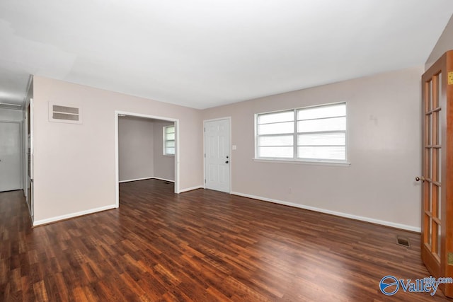 303 Bobwhite Dr SW, Decatur, AL 35601 - unfurnished living room with baseboards, dark wood-style floors, and visible vents