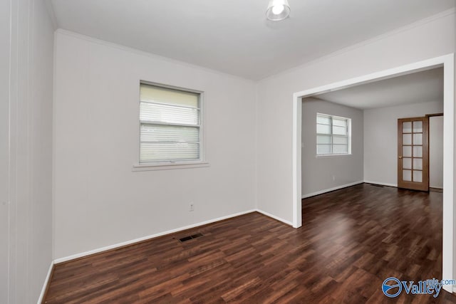 303 Bobwhite Dr SW, Decatur, AL 35601 - unfurnished room with crown molding, baseboards, and dark wood-style floors