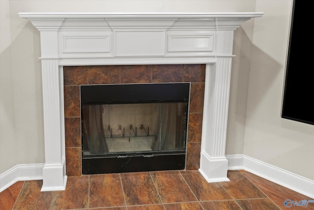 322 S Back Creek Rd, Madison, AL 35757 - detailed view of baseboards, a tiled fireplace, and wood finished floors