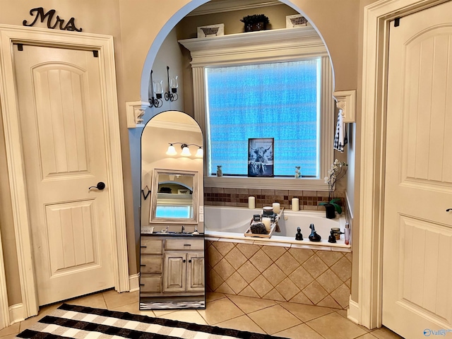 94 Owensby Way, Trinity, AL 35673 - kitchen with light tile patterned flooring, arched walkways, and a sink