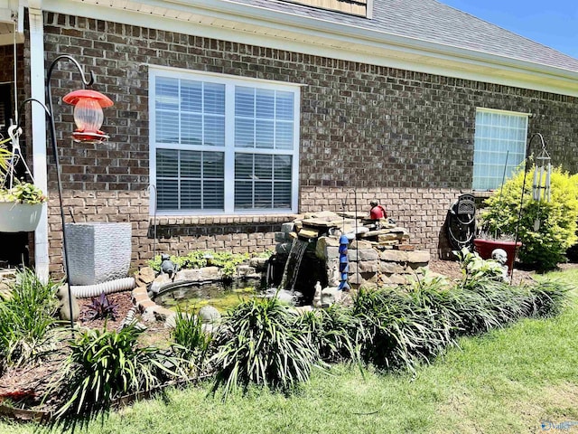 94 Owensby Way, Trinity, AL 35673 - exterior space featuring brick siding, roof with shingles, and gutters