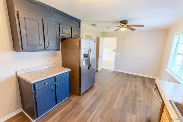 kitchen with ceiling fan, ornamental molding, stainless steel appliances, and light hardwood / wood-style floors