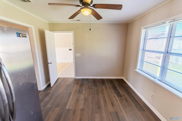 spare room with crown molding, dark wood-type flooring, and a textured ceiling