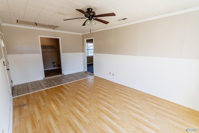 unfurnished room featuring hardwood / wood-style flooring, ceiling fan, and ornamental molding