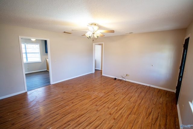 unfurnished room featuring ceiling fan, hardwood / wood-style floors, and a textured ceiling