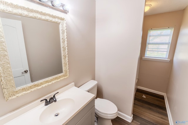 bathroom featuring vanity, hardwood / wood-style floors, and toilet