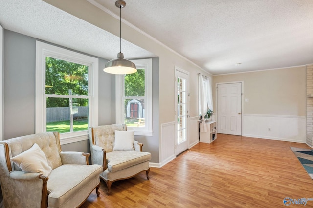 9410 Valley Ln, Huntsville, AL 35803 - living area featuring a textured ceiling, light wood-style floors, plenty of natural light, ornamental molding, and baseboards