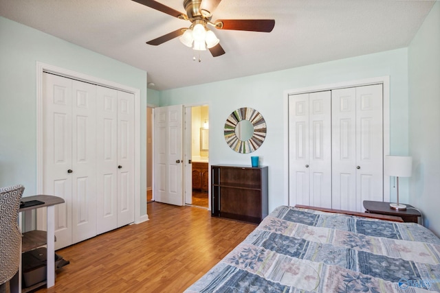 9410 Valley Ln, Huntsville, AL 35803 - bedroom with multiple closets, wood finished floors, and a ceiling fan