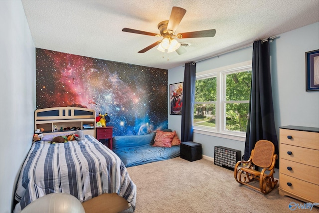9410 Valley Ln, Huntsville, AL 35803 - carpeted bedroom with a textured ceiling, an accent wall, a ceiling fan, and baseboards