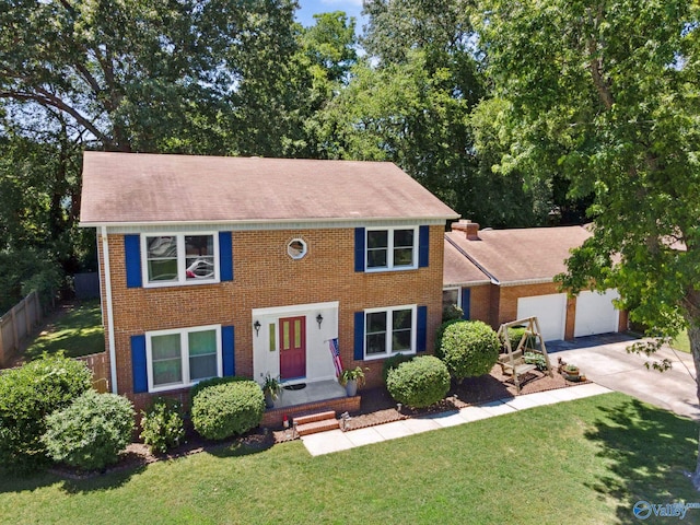 9410 Valley Ln, Huntsville, AL 35803 - colonial inspired home with a garage, brick siding, driveway, and roof with shingles