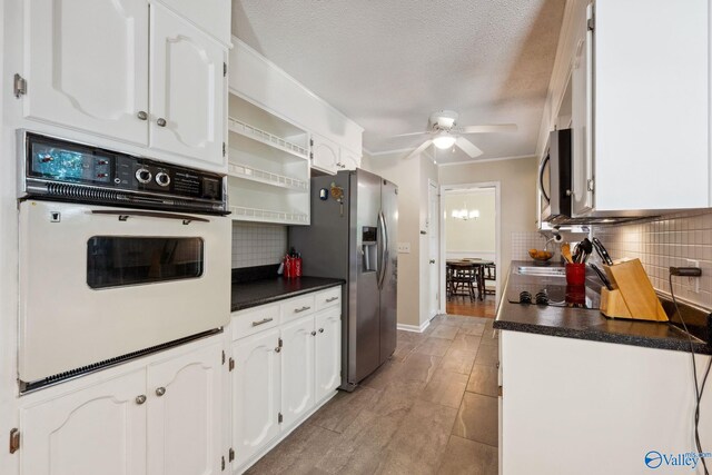 9410 Valley Ln, Huntsville, AL 35803 - kitchen with stainless steel appliances, dark countertops, ceiling fan, white cabinetry, and a textured ceiling