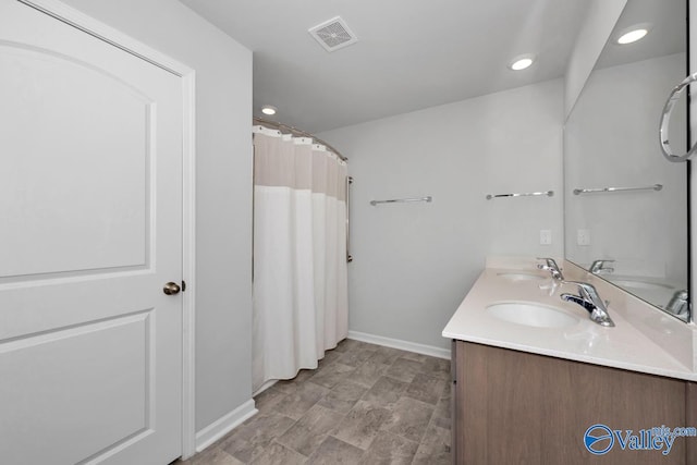 bathroom with vanity and walk in shower