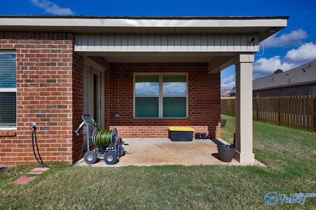 rear view of property with a lawn and a patio