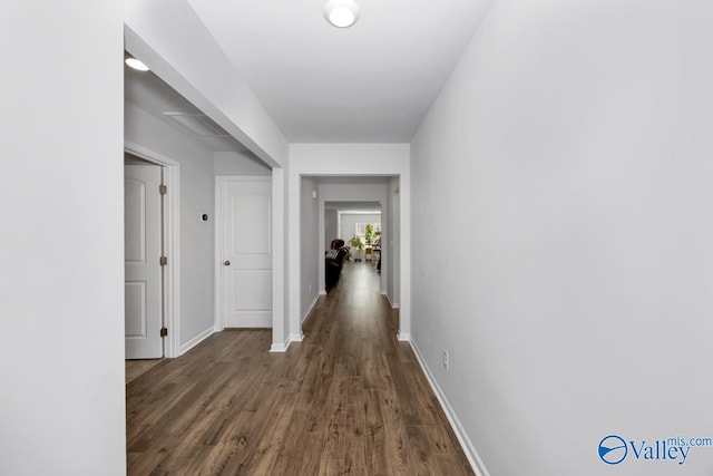 hallway with dark hardwood / wood-style floors