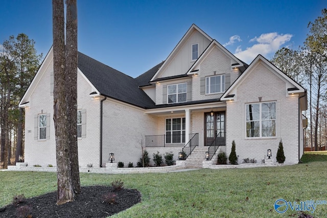 craftsman inspired home featuring a front yard and covered porch