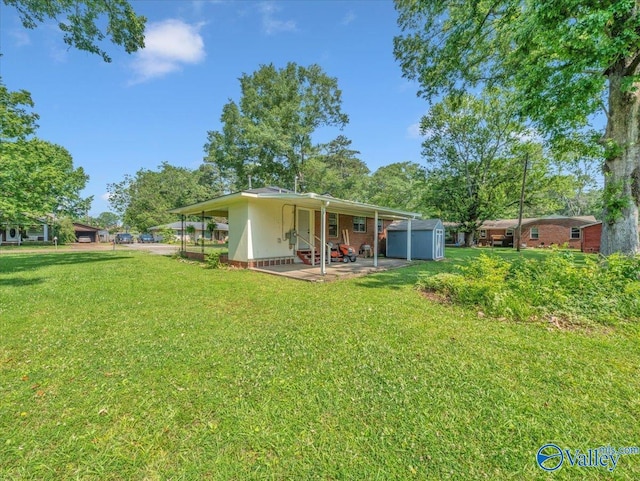 605 Hereford Dr, Athens, AL 35611 - back of house featuring a patio, a yard, and a storage shed
