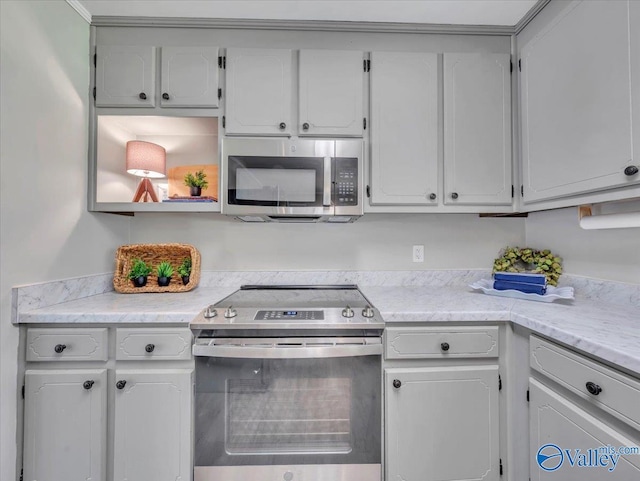 605 Hereford Dr, Athens, AL 35611 - kitchen with stainless steel appliances, light countertops, and white cabinetry