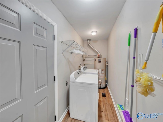 605 Hereford Dr, Athens, AL 35611 - laundry area with water heater, light wood-style floors, independent washer and dryer, and baseboards