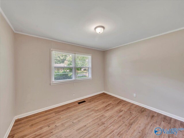 605 Hereford Dr, Athens, AL 35611 - empty room featuring wood finished floors, baseboards, and crown molding
