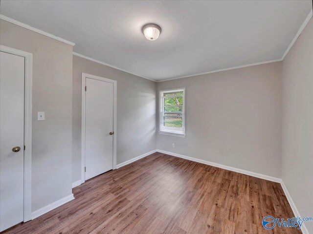 605 Hereford Dr, Athens, AL 35611 - empty room featuring wood finished floors, baseboards, and crown molding
