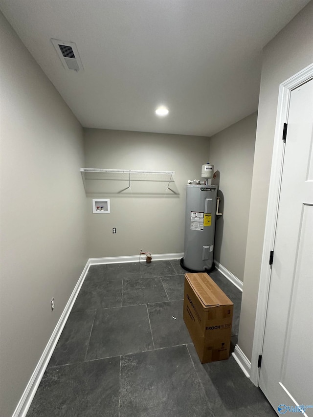 utility room featuring visible vents and electric water heater