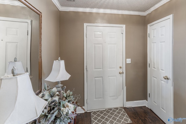 entrance foyer featuring a textured ceiling, dark wood-type flooring, and ornamental molding