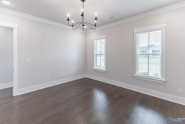 unfurnished room with dark wood-type flooring, a notable chandelier, ornamental molding, and plenty of natural light