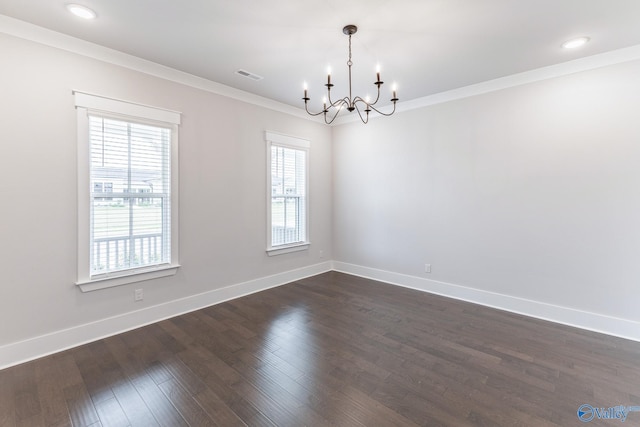 empty room with a chandelier, dark hardwood / wood-style flooring, and a wealth of natural light