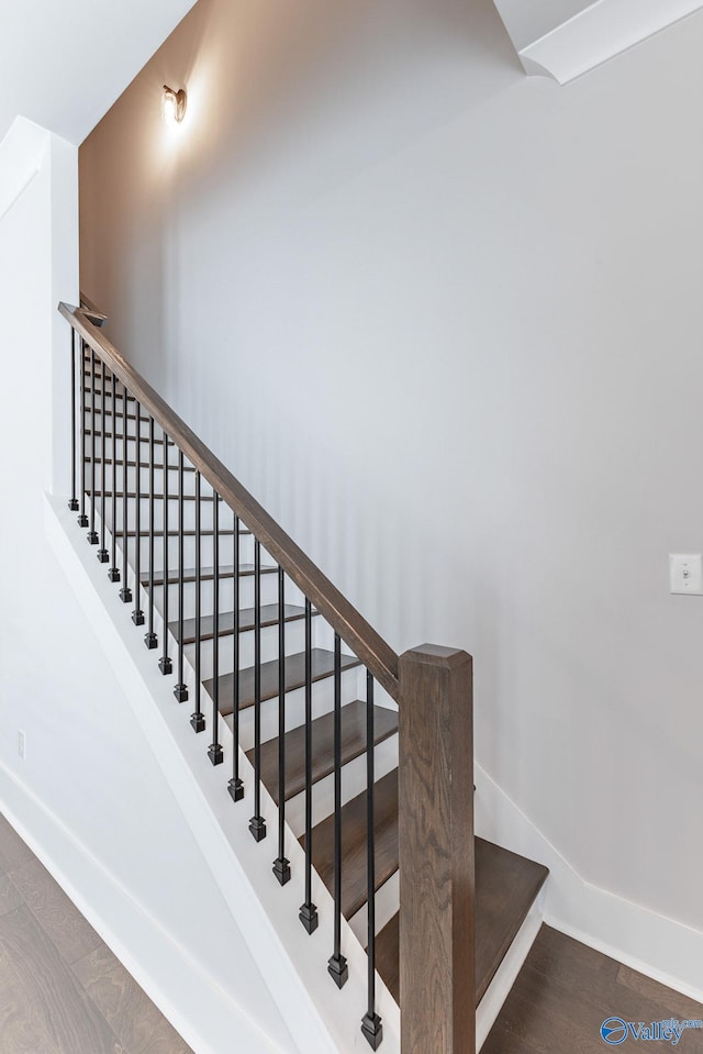 stairs featuring hardwood / wood-style flooring