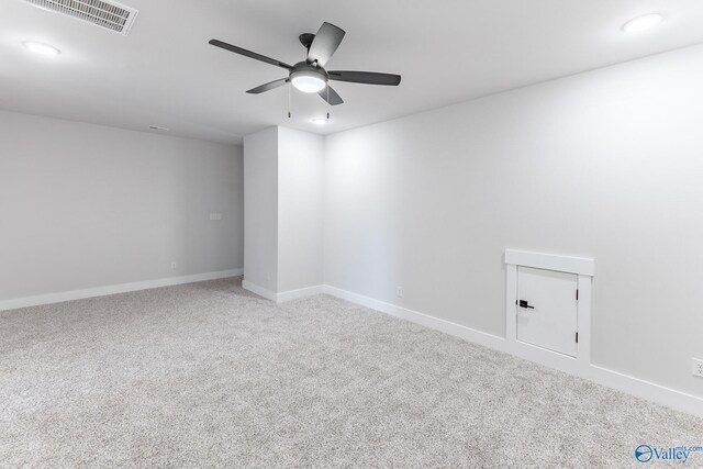 carpeted spare room featuring ceiling fan